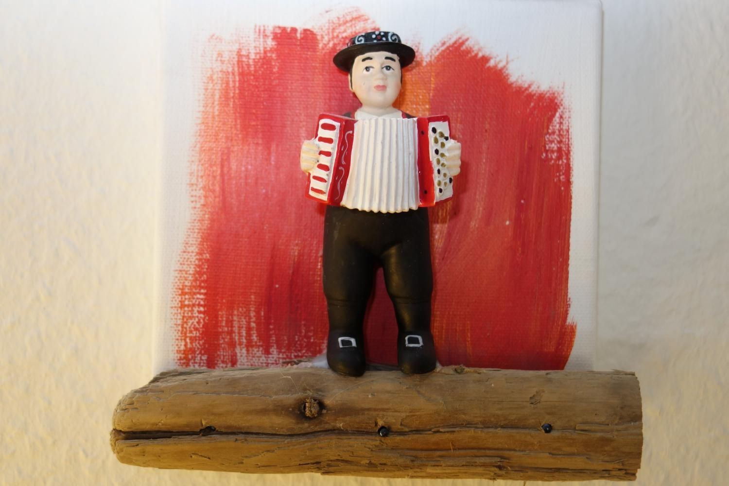 Decorative figurine playing an accordion