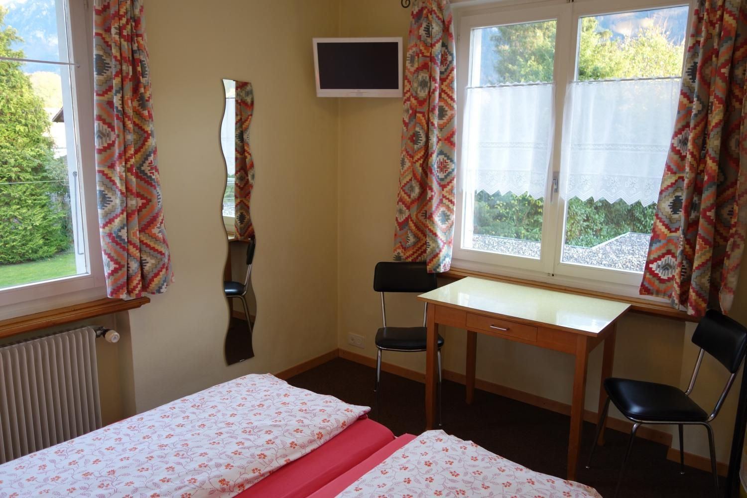 Standard Double Room: double bed, desk and wall-mounted TV