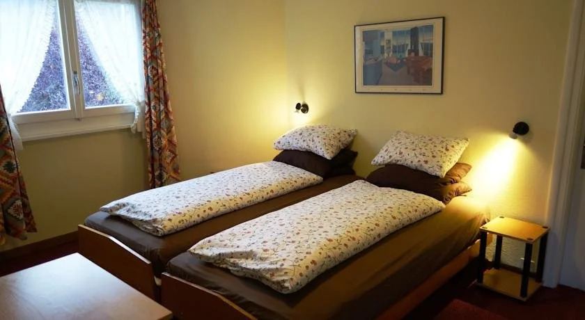 Guest room with wooden furniture and twin beds